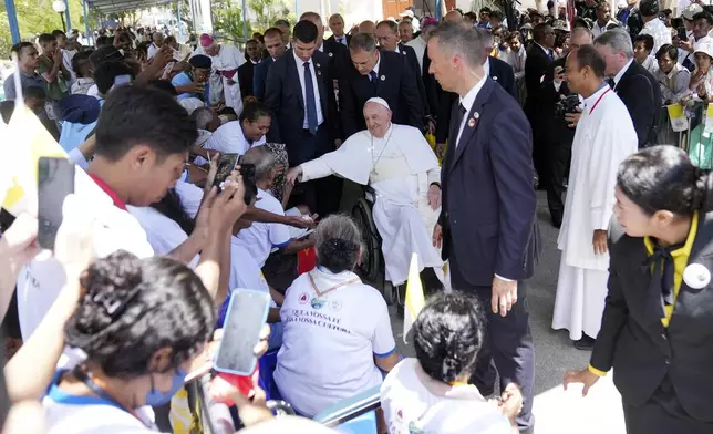 Pope Francis greets the people after the holy mass at the Cathedral of the Immaculate Conception in Dili, East Timor, Tuesday, Sept. 10, 2024. (AP Photo/Dita Alangkara)