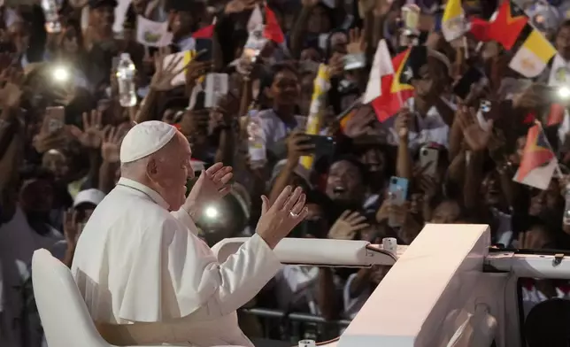 Pope Francis gestures as he leaves after leading a holy mass at Tasitolu park in Dili, East Timor, Tuesday, Sept. 10, 2024. (AP Photo/Dita Alangkara, Pool)