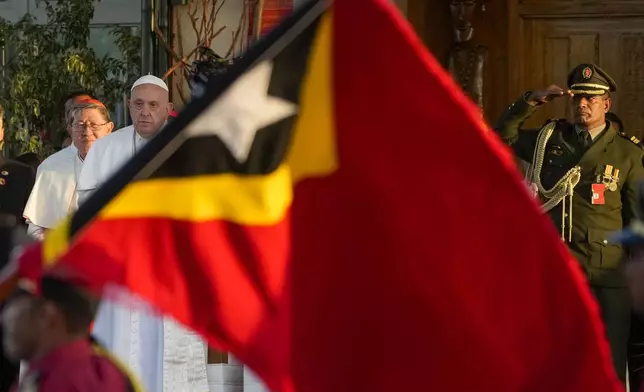 Pope Francis with Cardinal Luis Antonio Tagle Vatican Pro-prefect of the Dicastery for Evangelization, left, attends a welcome ceremony outside the Presidential Palace in Dili, East Timor, Monday, Sept. 9, 2024. Pope Francis arrived in East Timor on Monday to encourage its recovery from a bloody and traumatic past and celebrate its development after two decades of independence from Indonesian rule. (AP Photo/Gregorio Borgia)