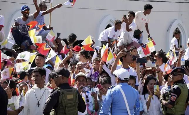 People wait for Pope Francis to arrive at the Cathedral of the Immaculate Conception in Dili, East Timor, Tuesday, Sept. 10, 2024. (AP Photo/Firdia Lisnawati)