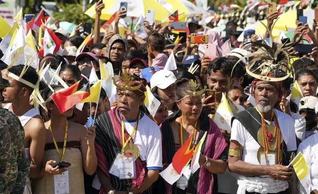 People wait for Pope Francis to arrive at the Cathedral of the Immaculate Conception in Dili, East Timor, Tuesday, Sept. 10, 2024. (AP Photo/Firdia Lisnawati)