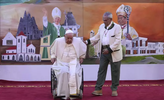 Pope Francis is helped by East Timor President Jose Ramos-Horta to get up from his wheelchair during the welcome ceremony at the Presidential Palace in Dili, East Timor, Monday, Sept. 9, 2024. (AP Photo/Dita Alangkara, Pool)