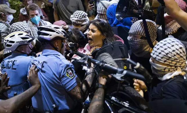 Philadelphia Police push pro-Palestinian protesters out of the street during the presidential debate between Democratic presidential nominee Vice President Kamala Harris and Republican presidential nominee former President Donald Trump in Philadelphia, Tuesday, Sept. 10, 2024. (AP Photo/Ryan Collerd)