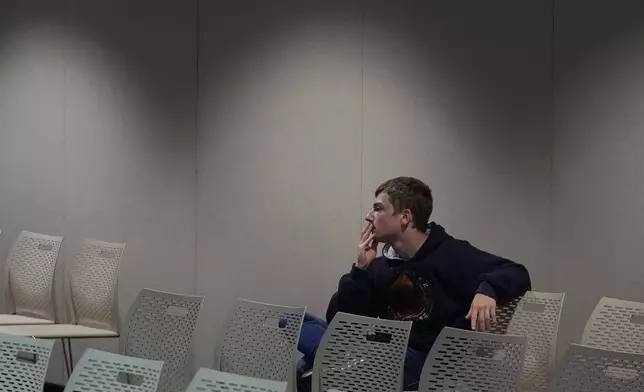 Tristan McPherson watches the presidential debate between Republican presidential nominee former President Donald Trump and Democratic presidential nominee Vice President Kamala Harris, Tuesday, Sept. 10, 2024, in Muncie, Ind. (AP Photo/Darron Cummings)