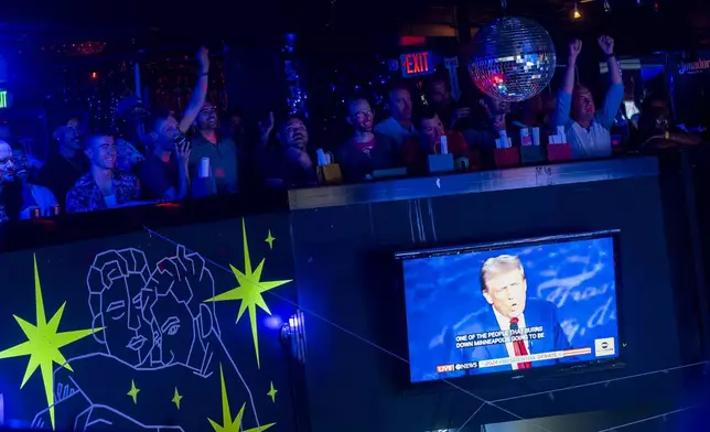 Attendees cheer and laugh as Republican presidential nominee former President Donald Trump mentions Seattle during a debate against Democratic presidential nominee Vice President Kamala Harris at a watch party at Massive, a queer nightclub, Tuesday, Sept. 10, 2024, in Seattle. (AP Photo/Lindsey Wasson)