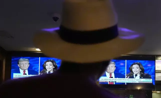 Charles Hudson, 76, from Chicago, watches the presidential debate between Republican presidential nominee former President Donald Trump and Democratic presidential nominee Vice President Kamala Harris at the Knotty Luxe Bistro, Tuesday, Sept. 10, 2024, in Markham, Ill. (AP Photo/Charles Rex Arbogast)