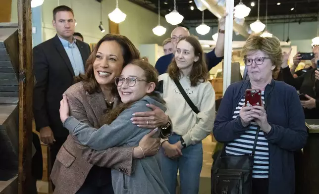 Democratic presidential nominee Vice President Kamala Harris, second from left, takes a photo as she visits Penzeys Spices on a campaign stop, Saturday, Sept. 7, 2024, in Pittsburgh. (AP Photo/Rebecca Droke)