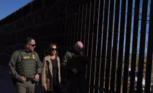 Democratic presidential nominee Vice President Kamala Harris talks with John Modlin, the chief patrol agent for the Tucson Sector of the U.S. Border Patrol, right, and Blaine Bennett, the U.S. Border Patrol Douglas Station border patrol agent in charge, as she visits the U.S. border with Mexico in Douglas, Ariz., Friday, Sept. 27, 2024. (AP Photo/Carolyn Kaster)