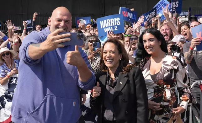 Democratic presidential nominee Vice President Kamala Harris takes a selfie with Sen. John Letterman, D-Pa., and his wife Gisele Barreto Fetterman, after Harris arrived at John Murtha Johnstown-Cambria Airport, in Johnstown, Pa., for a campaign event, Friday, Sept. 13, 2024. (AP Photo/Jacquelyn Martin)