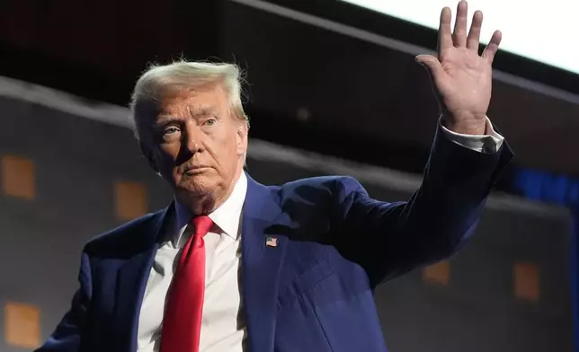 Republican presidential nominee former President Donald Trump waves as he departs a campaign event at the Economic Club of New York, Thursday, Sept. 5, 2024, in New York. (AP Photo/Alex Brandon)