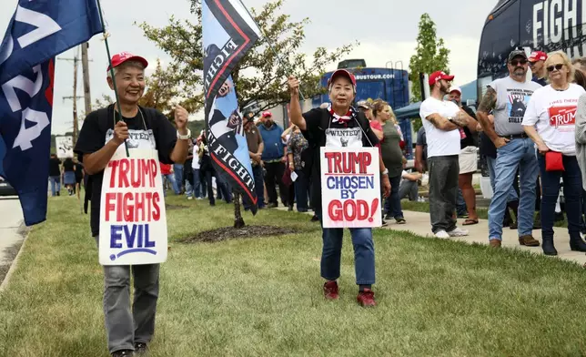 Katie Mimura, left, and Hisako Kaneko, center, who traveled from Japan to show support for Republican presidential nominee former President Donald Trump walk outside before a rally at Ed Fry Arena in Indiana, Pa., Monday, Sept. 23, 2024. (AP Photo/Rebecca Droke)