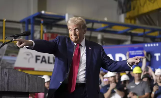 Republican presidential nominee former President Donald Trump gestures at a campaign event, Friday, Sept. 27, 2024 in Walker, Mich. (AP Photo/Carlos Osorio)