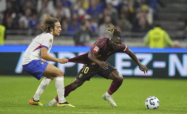 France's Matteo Guendouzi, left, tries to stop Belgium's Jeremy Doku during the UEFA Nations League soccer match between France and Belgium at the Groupama stadium in Decines, outside Lyon, France, Monday, Sept. 9, 2024. (AP Photo/Laurent Cipriani)