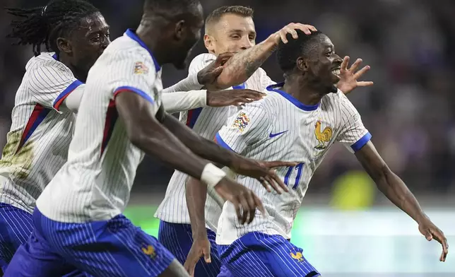 France's Ousmane Dembele, right, celebrates with teammates after scoring his side's second goal during the UEFA Nations League soccer match between France and Belgium at the Groupama stadium in Decines, outside Lyon, France, Monday, Sept. 9, 2024. (AP Photo/Laurent Cipriani)