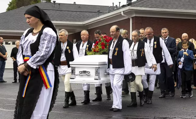 Mourners carry the casket of Ana Cristina Irimie, a math teacher killed during a shooting at Apalachee High School, after her funeral service at Hamilton Mill Memorial Chapel and Gardens in Buford, Ga., on Saturday, Sept. 14, 2024. (Arvin Temkar/Atlanta Journal-Constitution via AP)