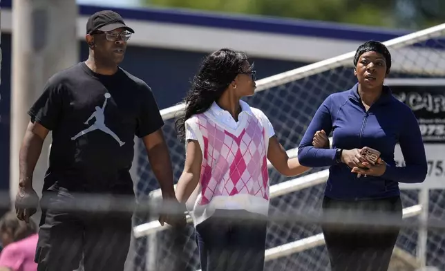 Parents walk their child out of Apalachee High School after a shooting at the school Wednesday, Sept. 4, 2024, in Winder, Ga. (AP Photo/Mike Stewart)