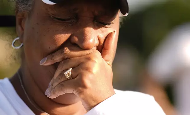 Chimain Douglas, of Grayson, Ga., cries near Apalachee High School as she mourns for the slain students and teachers on Thursday, Sept. 5, 2024, in Winder, Ga. (AP Photo/Brynn Anderson)