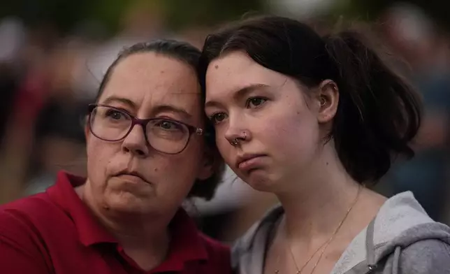 Mourners hold candles during a candlelight vigil for the slain students and teachers at Apalachee High School, Wednesday, Sept. 4, 2024, in Winder, Ga. (AP Photo/Mike Stewart)