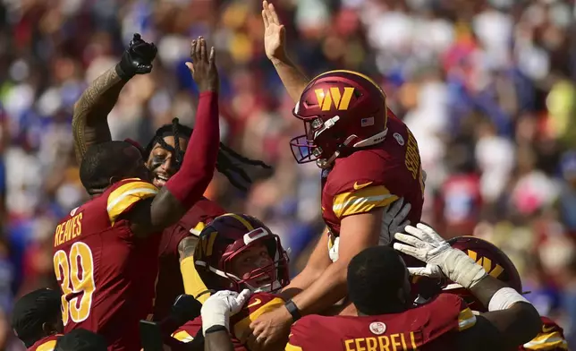 Washington Commanders place kicker Austin Seibert, top right, celebrates with teammate after kicking the game-winning field goal against the New York Giants during the second half of an NFL football game in Landover, Md., Sunday, Sept. 15, 2024. (AP Photo/Steve Ruark)