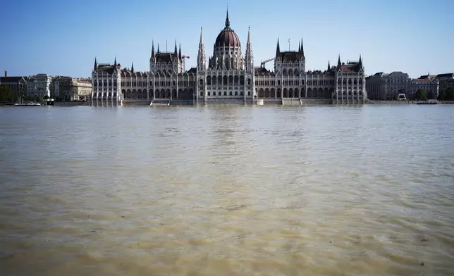 General view of the Parliament building as the Danube river floods its banks, central Budapest, Hungary, Thursday, Sept. 19, 2024. (AP Photo/Denes Erdos)