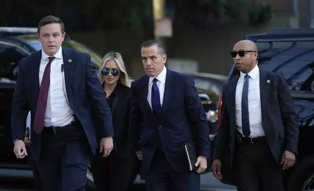 Hunter Biden, center, and his wife Melissa Cohen Biden, arrive in federal court for jury selection for his trial on felony tax charges Thursday, Sept. 5, 2024, in Los Angeles. (AP Photo/Jae C. Hong)