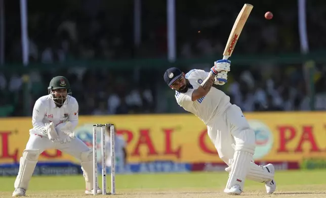 India's Virat Kohli, right, plays a shot on the fourth day of the second cricket test match between Bangladesh and India in Kanpur, India, Monday, Sept. 30, 2024. (AP Photo/Ajit Solanki)