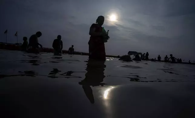 Hindu devotees holy dips during Teej festival, at Sangam, the confluence of rivers Ganges and Yamuna in Prayagraj, Uttar Pradesh, India, Friday, Sept. 6, 2024. (AP Photo/Rajesh Kumar Singh)