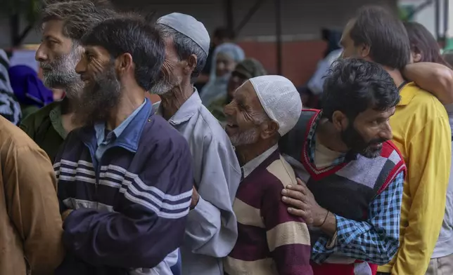 People queue up at a polling booth to cast their vote in Naira, south of Srinagar, Indian controlled Kashmir, Wednesday, Sept. 18, 2024. (AP Photo/Dar Yasin)