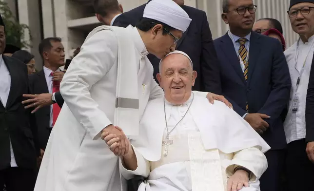 The Grand Imam Nasaruddin Umar, left, bids farewell to Pope Francis, as he leaves after signing the "Joint Declaration of Istiqlal 2024" at the Istiqlal Mosque in Jakarta, Thursday, Sept. 5, 2024. Pope Francis urged Indonesia to live up to its promise of "harmony in diversity" and fight religious intolerance on Wednesday, as he set a rigorous pace for an 11-day, four-nation trip through tropical Southeast Asia and Oceania. (AP Photo/Gregorio Borgia)