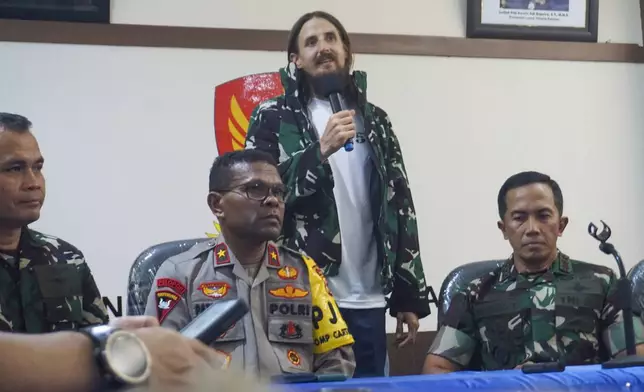 New Zealand pilot Phillip Mehrtens, center, who was held hostage for more than a year in the restive Papua region, talks to the media during a news conference after his release, in Timika, Papua province, Indonesia, Saturday, Sept. 21, 2024. (AP Photo/Endy Langobelen)