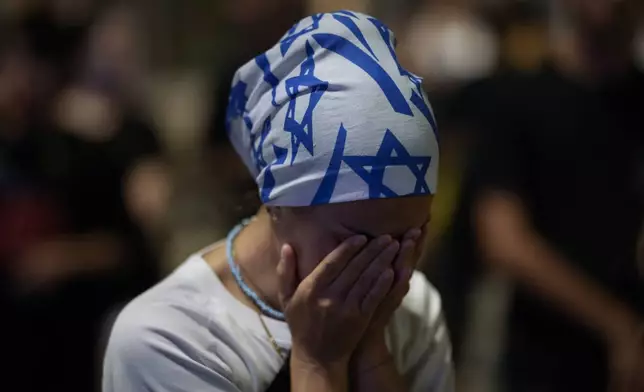 A demonstrator reacts during a protest against Prime Minister Benjamin Netanyahu's government and call for the release of hostages held in the Gaza Strip by the Hamas militant group, in Tel Aviv, Israel, Saturday, Sept. 7, 2024. (AP Photo/Leo Correa)