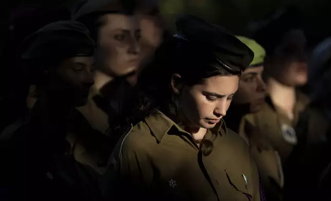 Female soldiers attend the funeral for Israeli Defense Forces paramedic Sgt. Agam Naim, the first woman Israeli Defense Forces soldier killed in combat in the Gaza Strip, in Kibbutz Mishmarot, Israel, Wednesday, Israel, Sept. 18, 2024. (AP Photo/Maya Alleruzzo)