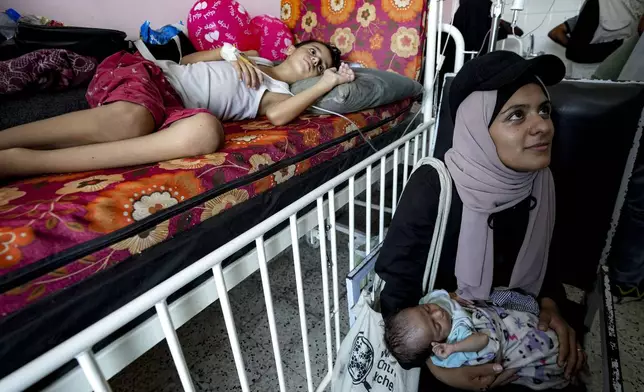 Palestinian children wait to receive a polio vaccination at a hospital in Khan Younis, Saturday, Aug. 31, 2024. (AP Photo/Abdel Kareem Hana)