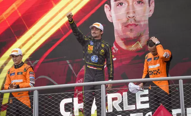 Ferrari driver Charles Leclerc of Monaco, centre, celebrates on the podium with second placed McLaren driver Oscar Piastri of Australia, left, and third McLaren driver Lando Norris of Britain after the Formula One Italian Grand Prix race at the Monza racetrack, in Monza, Italy, Sunday, Sept. 1, 2024. (AP Photo/Luca Bruno)