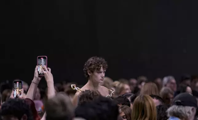 A model wears a creation as part of the Prada Spring Summer 2025 collection, that was presented in Milan, Italy, Thursday, Sept. 19, 2024. (AP Photo/Luca Bruno).