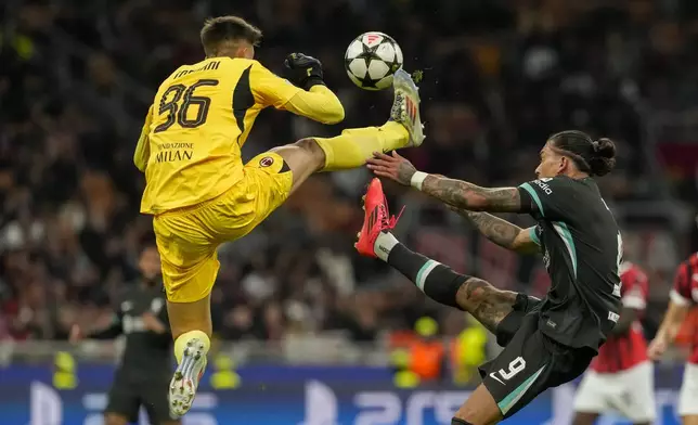 Liverpool's Darwin Nunez, right, and AC Milan's goalkeeper Lorenzo Torriani fight for the ball during the Champions League opening phase soccer match between AC Milan and Liverpool at the San Siro stadium in Milan, Italy, Tuesday, Sept. 17, 2024. (AP Photo/Luca Bruno)