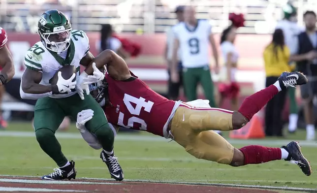 New York Jets running back Breece Hall (20) runs against San Francisco 49ers linebacker Fred Warner (54) during the first half of an NFL football game in Santa Clara, Calif., Monday, Sept. 9, 2024. (AP Photo/Godofredo A. Vásquez)