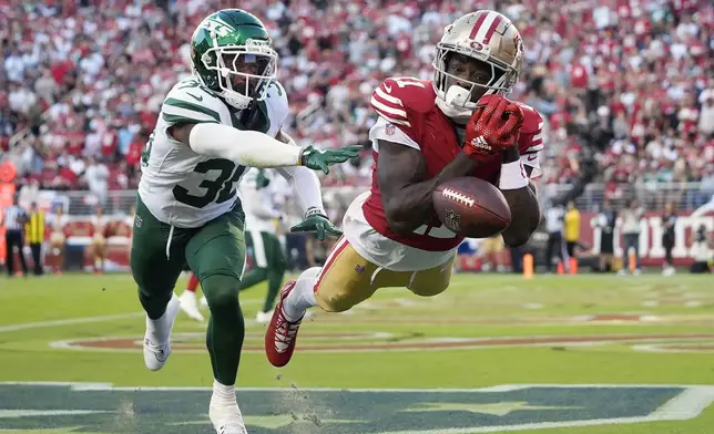 San Francisco 49ers wide receiver Brandon Aiyuk, right, cannot catch a pass against New York Jets cornerback Michael Carter II in the end zone during the first half of an NFL football game in Santa Clara, Calif., Monday, Sept. 9, 2024. (AP Photo/Godofredo A. Vásquez)