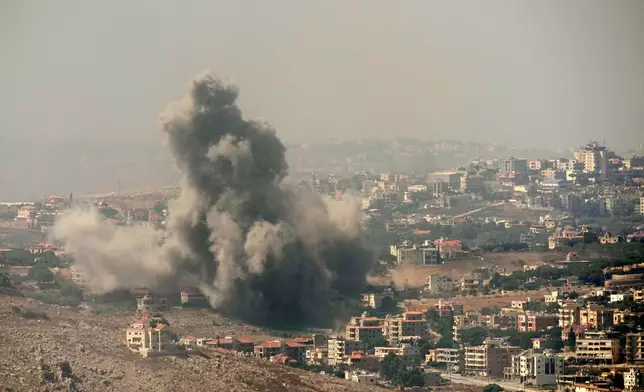 Smoke rises from Israeli airstrikes in the southern village of Kfar Rouman, seen from Marjayoun, south Lebanon, Wednesday, Sept. 25, 2024. (AP Photo/Hussein Malla)