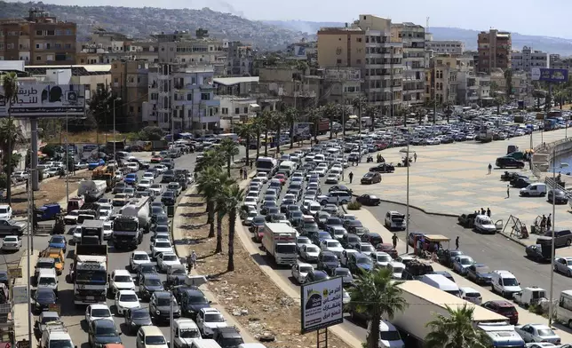 Cars sit in traffic as they flee the southern villages amid ongoing Israeli airstrikes, in Sidon, Lebanon, Monday, Sept. 23, 2024. (AP Photo/Mohammed Zaatari)