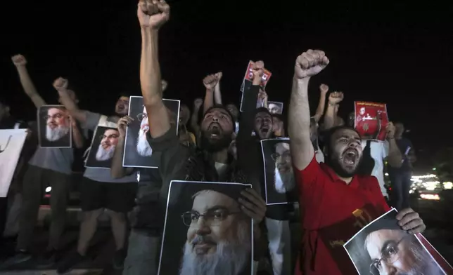 Lebanese and Palestinian men hold portraits of Hezbollah leader Sayyed Hassan Nasrallah, as they shout slogans during a protest in the southern port city of Sidon, Lebanon, Saturday, Sept. 28, 2024. (AP Photo/Mohammed Zaatari)