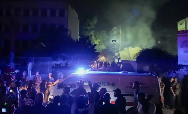 Ambulances arrive at the site of an Israeli airstrike in Beirut's southern suburbs Friday, Sept. 27, 2024. (AP Photo/Bilal Hussein)