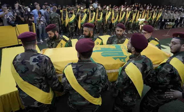 Hezbollah members carry the coffin of Hezbollah drone commander, Mohammed Hussein Surour, during his funeral procession in Beirut's southern suburbs, Friday, Sept. 27, 2024. (AP Photo/Bilal Hussein)