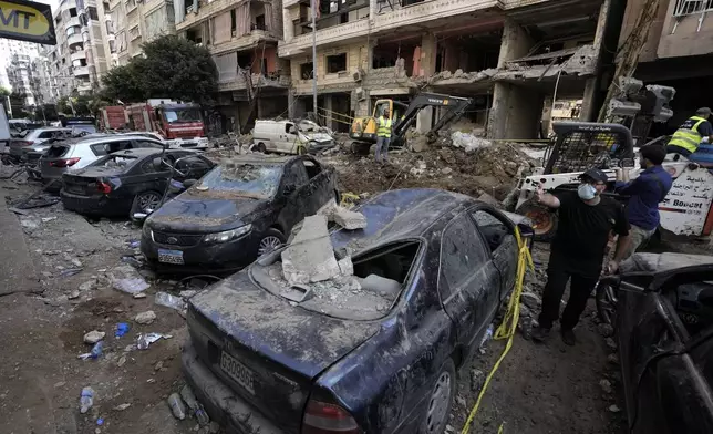 Damaged cars at the site of Friday's Israeli strike in Beirut's southern suburbs, Saturday, Sept. 21, 2024. (AP Photo/Bilal Hussein)