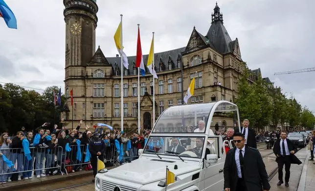 Pope Francis and Archbishop of Luxembourg, Cardinal Jean-Claude Hollerich, right, tour Place de Metz in Luxembourg on the first day of Francis's four-day visit to Luxembourg and Belgium, Thursday, Sept. 26, 2024. (AP Photo/Geert Vanden Wijngaert)