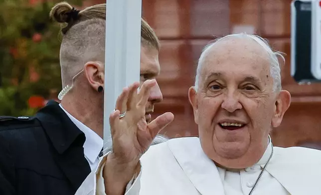 Pope Francis, flanked by security, tours Place de Metz in Luxembourg on the first day of Francis's four-day visit to Luxembourg and Belgium, Thursday, Sept. 26, 2024. (AP Photo/Geert Vanden Wijngaert)