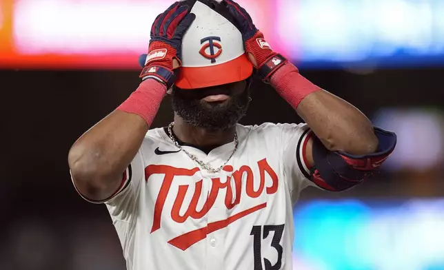 Minnesota Twins' Manuel Margot (13) reacts after hitting a pop out to first during the fifth inning of a baseball game against the Miami Marlins, Tuesday, Sept. 24, 2024, in Minneapolis. (AP Photo/Abbie Parr)