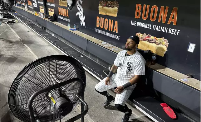 Chicago White Sox's Corey Julks sits in the end of the bench after the team's 5-3 loss to the New York Mets Saturday, Aug. 31, 2024, that saw the White Sox tie the franchise season record of 106 losses in Chicago. (AP Photo/Charles Rex Arbogast)