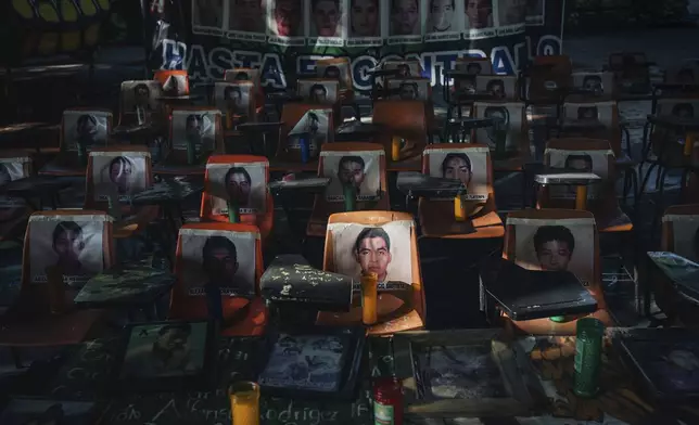 Photos of 43 students who have been missing for 10 years cover the stairs at their former Raúl Isidro Burgos Rural Normal School in Ayotzinapa, Guerrero state, Mexico, Saturday, Aug. 24, 2024. (AP Photo/Felix Marquez)