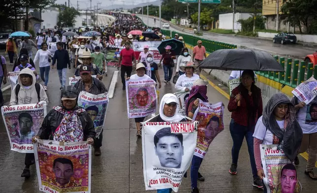 Relatives of the 43 Ayotzinapa students who went missing almost 10 years ago march to demand justice for their loved ones in Chilpancingo, Mexico, Wednesday, Sept. 18, 2024. (AP Photo/Felix Marquez)